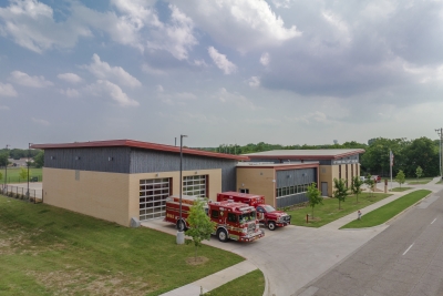 Aerial photo of the public safety building with a fire truck and ambulance parked in front of it.
