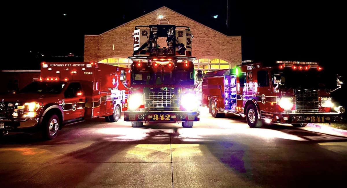 Photo of emergency vehicles in front of Fire Station 2 at night